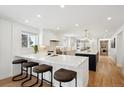 Bright and airy kitchen with white cabinets, quartz countertops, and a large center island at 6279 E Princeton Ave, Cherry Hills Village, CO 80111