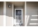 Inviting entryway with decorative security door and modern light fixture at 6001 S Yosemite St # B206, Greenwood Village, CO 80111