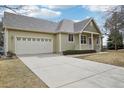 Inviting home featuring an attached two-car garage and a long driveway at 616 Wild Ridge Cir, Lafayette, CO 80026