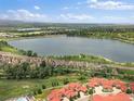 Stunning aerial view of townhomes near a large lake, capturing the scenic beauty and desirable location at 2468 Channel Dr, Highlands Ranch, CO 80129