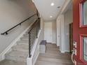 Inviting entryway with a staircase, modern railing, and stylish bench seating at 2468 Channel Dr, Highlands Ranch, CO 80129