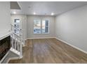Bright living room with hardwood floors and a fireplace at 14948 E Belleview Ave, Aurora, CO 80015