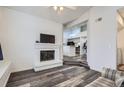 Bright living room features a brick fireplace and steps up to the kitchen with an open floor plan at 4760 S Wadsworth Blvd # M302, Littleton, CO 80123