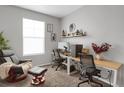 Home office featuring two desks, ergonomic chairs, and a large window at 2523 Villageview Ln, Castle Rock, CO 80104