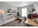 Bright home office with floating shelves, a large window, and comfortable seating at 2523 Villageview Ln, Castle Rock, CO 80104