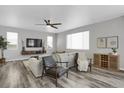 Spacious living room with a neutral color palette, a large sectional sofa and hardwood floors at 2523 Villageview Ln, Castle Rock, CO 80104