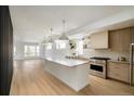 Bright and airy kitchen with hardwood floors, a large island, and stainless steel appliances at 2738 N Clay St, Denver, CO 80211