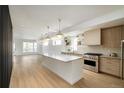 Bright, open kitchen with a large island, stainless steel appliances, and hardwood flooring at 2738 N Clay St, Denver, CO 80211