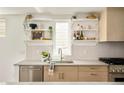 Close up of the kitchen area, showcasing updated counters, faucet, backsplash, and shelving at 2738 N Clay St, Denver, CO 80211