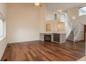 Bright living room with hardwood floors, fireplace, and staircase leading to an upper level at 23955 Glenmoor Way, Parker, CO 80138
