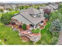 Aerial shot of back yard featuring mature landscaping, custom patio with fire pit, and outdoor seating at 7949 S Blackstone Pkwy, Aurora, CO 80016
