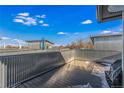 Bright rooftop deck with modern railings, offering an inviting outdoor living space and clear blue skies at 4144 Tennyson St # 10, Denver, CO 80212