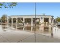 Corner building with multiple storefronts along a street, crosswalk and wet street at 4144 Tennyson St # 10, Denver, CO 80212