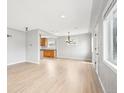 Open-concept living room with hardwood floors and views into the dining area and kitchen at 1632 S Josephine St, Denver, CO 80210