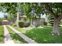 Charming single-story home with a well-manicured lawn and mature trees in a desirable neighborhood at 3061 S Marion St, Englewood, CO 80113