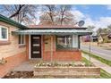 Welcoming front porch area featuring a brick facade, colorful flower bed, and a 'Welcome' doormat at 2259 Meade St, Denver, CO 80211