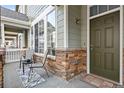 Inviting front porch with seating area and welcome mat at 15945 E Geddes Dr # 54, Aurora, CO 80016