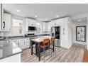 Well-lit kitchen featuring white cabinets, stainless steel appliances, and a functional island at 10051 Belvedere Cir, Lone Tree, CO 80124
