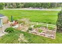 Elevated shot showcasing a charming backyard garden with raised planters and outdoor seating at 10869 W 65Th Way, Arvada, CO 80004