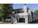 Multi-story townhome with garage, balcony and gray facade, offering a modern and stylish appearance at 1180 S Monaco Pkwy # 3, Denver, CO 80224