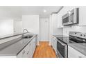 Modern kitchen featuring white cabinets, stainless steel appliances, and sleek countertops at 1180 S Monaco Pkwy # 3, Denver, CO 80224