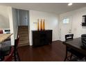 Dining room features a dark wood floor, large dining table and adjacent stairway at 7132 Xavier Way, Westminster, CO 80030