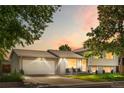 Evening shot of a well-kept two-story home, featuring a spacious front yard, wide driveway, and two-car garage at 7132 Xavier Way, Westminster, CO 80030