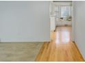 Inviting hallway featuring hardwood floors leading to a bright, open space at 3026 S Alton Ct, Denver, CO 80231