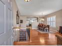 Inviting entryway with hardwood floors, staircase, and dining area with natural light at 7211 Dolomite Ln, Castle Rock, CO 80108