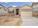 Charming single-Gathering home featuring stone accents, neutral siding, and a two-car garage at 874 Ledge St, Lochbuie, CO 80603