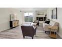 Bright living room featuring a fireplace, neutral furniture, and wood-look flooring at 7255 E Quincy Ave # 403, Denver, CO 80237