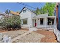 Charming exterior of a quaint home with a red front door and cozy front porch at 1324 Virginia St, Idaho Springs, CO 80452