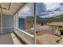 Inviting porch with mountain views and a white picket fence at 1324 Virginia St, Idaho Springs, CO 80452