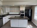 Spacious kitchen featuring stainless steel appliances, granite countertops, and a center island at 4338 N Ceylon Ct, Denver, CO 80249