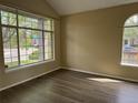Bright living room with large windows offering natural light and stylish laminate flooring at 4338 N Ceylon Ct, Denver, CO 80249