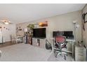 Open-concept living area with a home office setup and ample natural light at 7755 E Quincy Ave # 207A3, Denver, CO 80237