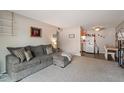 Comfortable living room showing seamless transition to adjacent kitchen and dining area at 7755 E Quincy Ave # 207A3, Denver, CO 80237