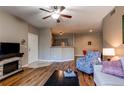 Open-concept living room with modern finishes, including a fireplace and wood floors at 1651 W Canal Cir # 613, Littleton, CO 80120