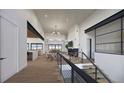 Open concept living area with hardwood floors and a modern fireplace at 5191 Lions Paw St, Castle Rock, CO 80104