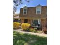 Attractive townhouse with a brick facade, complemented by colorful flowers and lush greenery at 8871 E Amherst Dr # B, Denver, CO 80231