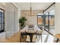 Dining area showcases modern lighting, stylish wallpaper, and seamless access to the outdoors at 4651 Alcott St, Denver, CO 80211