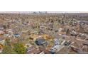 Wide aerial view of homes in an established neighborhood near city at 469 S Perry St, Denver, CO 80219