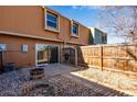 The back patio is fenced, and has a sliding glass door to the home at 10390 Tumbleweed Dr # 7, Thornton, CO 80229