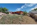 Spacious backyard with a covered patio, lawn and partial fencing at 2533 E 90Th Pl, Thornton, CO 80229
