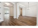 Bright living room with wood floors and a modern light fixture at 4723 Twelve Oaks Way, Castle Rock, CO 80104