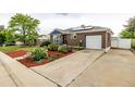 Classic brick home with solar panels, a long driveway, and meticulously maintained landscaping at 10478 Ogden St, Northglenn, CO 80233