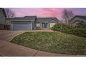 Charming single-Gathering home boasts a well-manicured lawn and a classic gray exterior at 5133 S Flanders Ln, Centennial, CO 80015