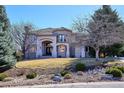 Beautiful two-story home showcases a well-kept lawn and detailed stone landscaping, enhancing its curb appeal at 10162 Prestwick Trl, Lone Tree, CO 80124