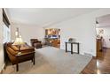 Cozy living room with plush carpeting, comfortable seating, and natural light at 8150 S Marshall Ct, Littleton, CO 80128
