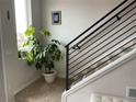 Modern staircase with sleek metal railings and a large window providing natural light at 2617 Channel Dr, Highlands Ranch, CO 80129